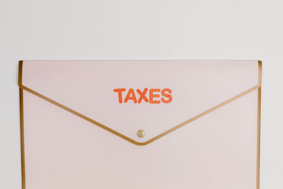 Minimalist pastel pink envelope labeled 'TAXES' perfect for finance or tax-themed visuals.
